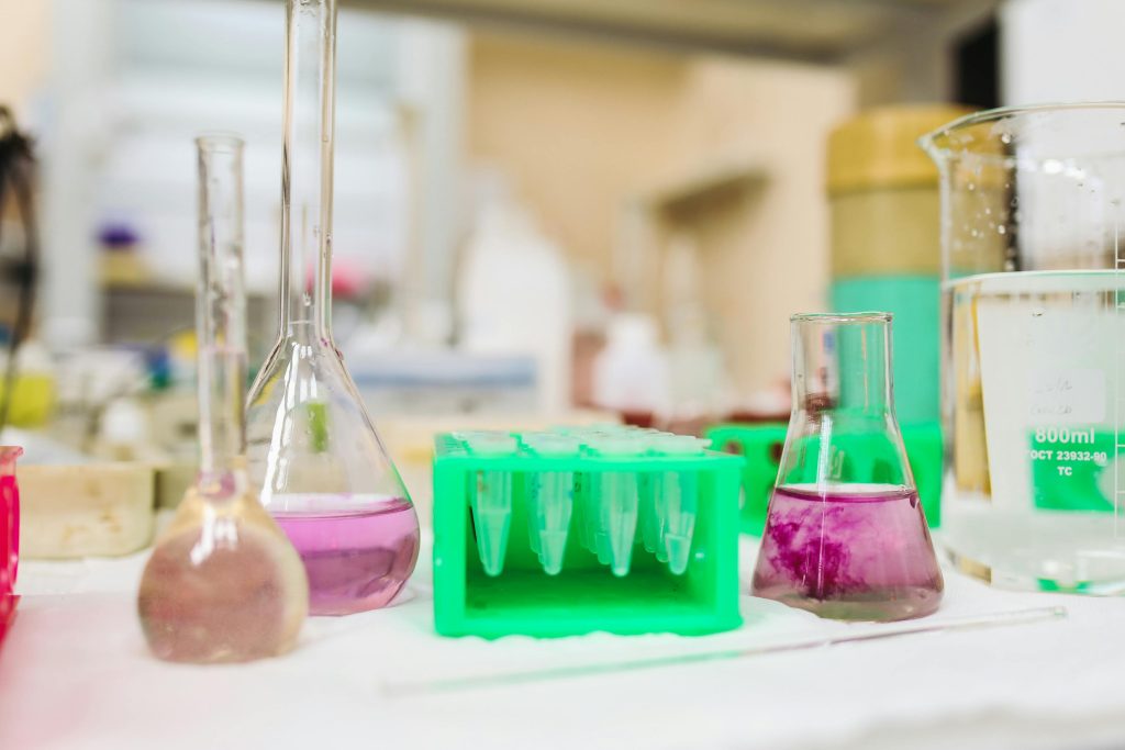 Researcher with small organic material in petri dish.